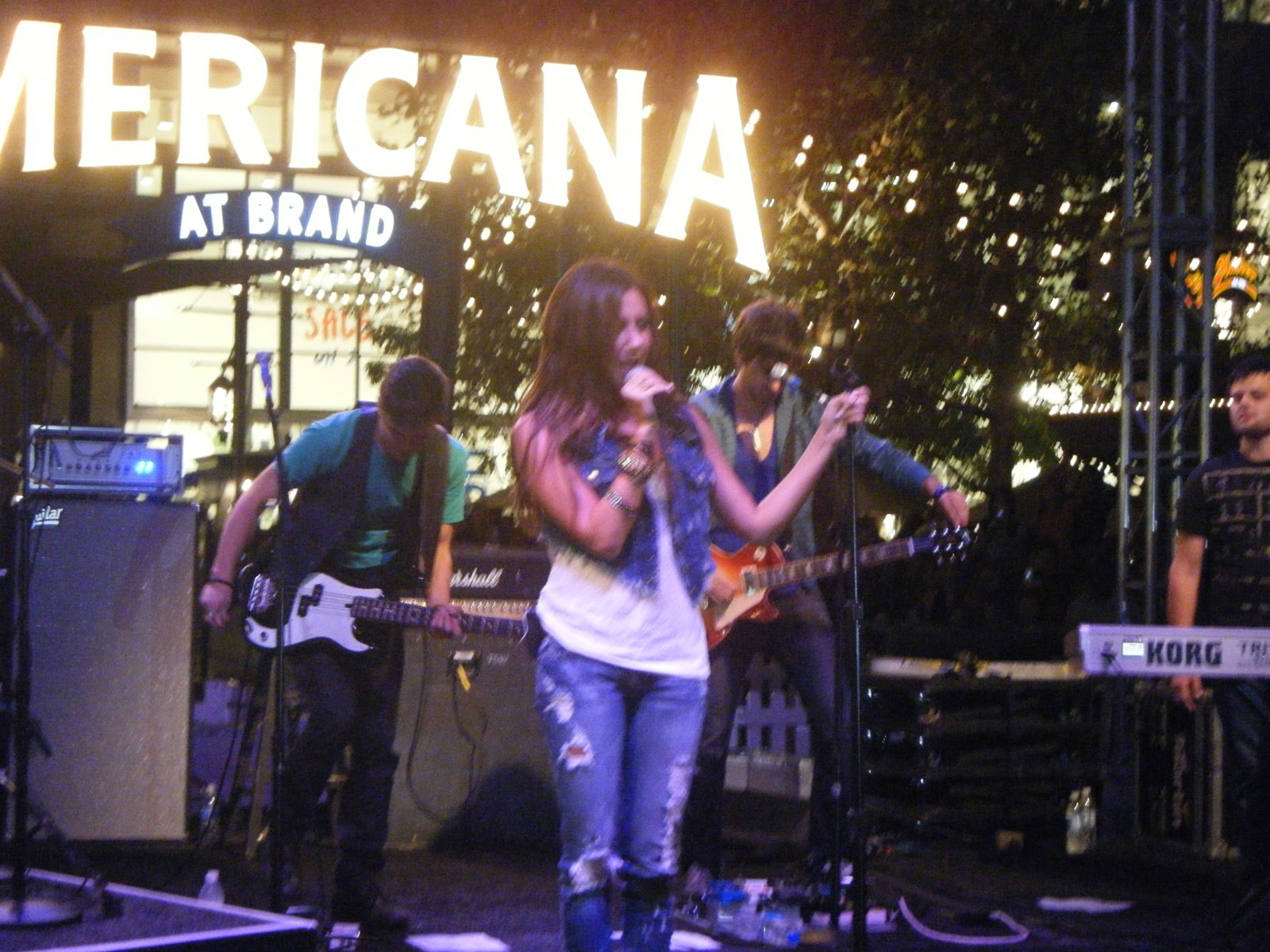 Ashley Tisdale performing with her band on stage at The Americana at Brand in Glendale, August 2009